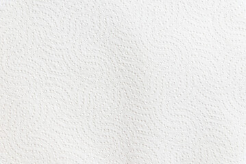 Fototapeta na wymiar White embossed paper towel texture background with copy space. Minimalist paper surface banner featuring a decorative embossed wave pattern.