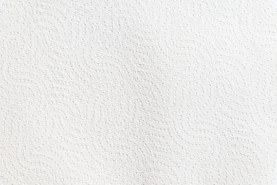 White embossed paper towel texture background with copy space. Minimalist paper surface banner featuring a decorative embossed wave pattern.