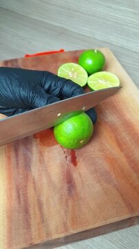 fresh lime, cutting board, black glove, sliced, citrus, fruit, knife, green, chef, kitchen, food, preparation, wooden, ingredient, juicy, sour, tropical, organic, raw, healthy, cooking, chop, slice, h