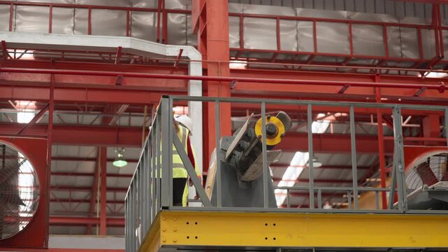 Engineering professionals and production technicians evaluate manufacturing machinery, discussing repair strategies, identifying production bottlenecks, implementing practical solutions, improving equ
