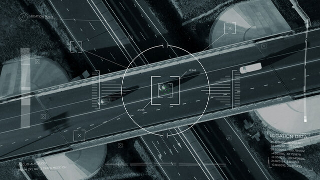 Surveillance system shows vehicles on road with tracking data displayed on screen