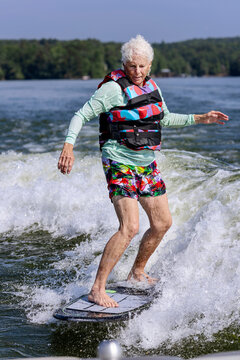 A woman wake surfs on a lake in Alabama