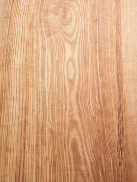 Natural ash wood surface with grain patterns, perfect for showcasing food styling or menu backgrounds