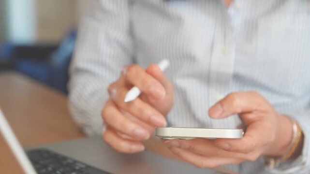 Smartphone Technology For Remote Work, Close Up Hands Using Mobile Phone Beside Laptop With Stylus, Digital Communication And Multitasking In Modern Home Workspace, Online Business Productivity
