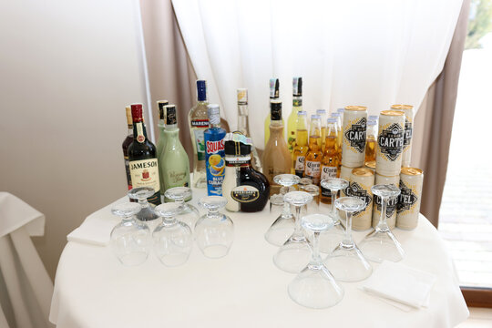 Table with Jameson, Sheridan's, Corona Extra, Squash and Se&ntilde;or Cartel alcoholic beverages prepared for a festive event.