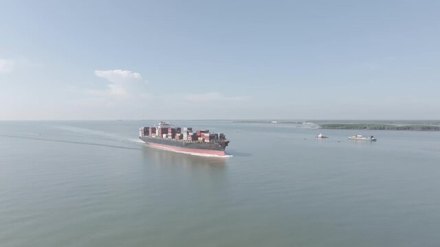 Aerial drone footage of container ships sailing across Ganh Rai Bay, Ho Chi Minh City, Vietnam, showcasing global maritime transport, busy shipping routes and coastal logistics.