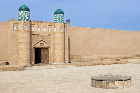 Kunya Ark citadel gate with twin turquoise-domed towers in Ichan Kala, Khiva, Uzbekistan. Ideal for travel guides, heritage publications, and cultural tourism materials.