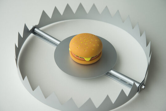 Hamburger fast food in a trap on white background. Junk foods, unhealthy, people office eating lifestyle, exercise concept. Junk foods are full high calories, fat and excess sodium that bad for health
