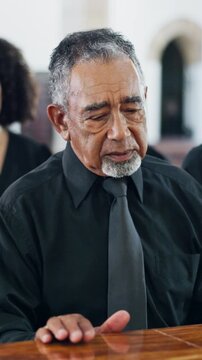 Sad, man and mourning at funeral with coffin, condolences or memorial service for deceased. Family, grieving and widower with casket at church for rip, final goodbye and burial for farewell ceremony