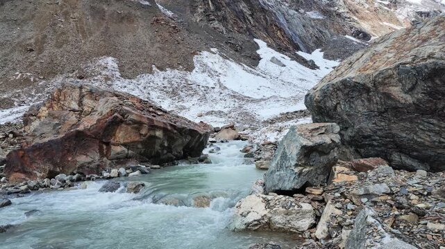 Rapid glacial river flowing through rocky mountains in Svaneti Georgia, icy water, wilderness landscape, mountain stream, nature travel scenery