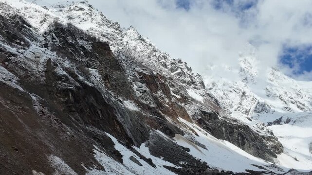 Rugged Chalaadi glacier landscape in Svaneti Georgia, steep snowy peaks, rocky mountain slopes, adventure travel, majestic alpine scenery, nature exploration