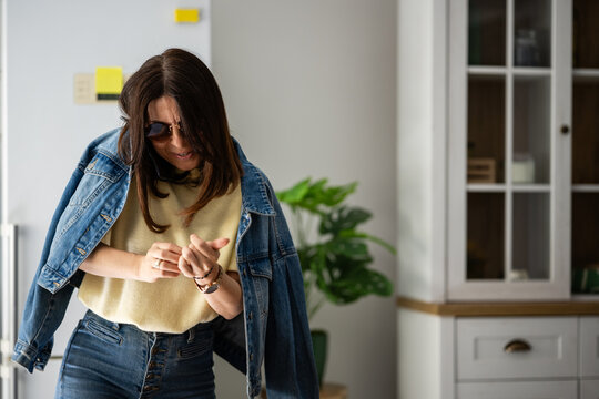 Woman getting dressed in hurry for leaving home