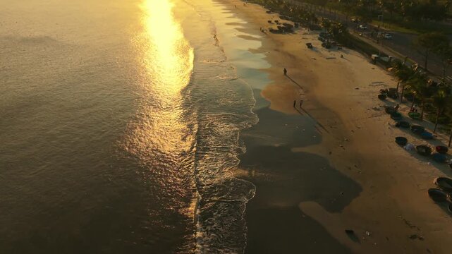 Vietnam, Da Nang Golden Sunrise Over Da Nang Beach, Aerial View Of Calm Coastline With Shimmering Water Reflection, Gentle Waves Washing Onto Sand Pools, Palm Fringed Promenade, Local Asian