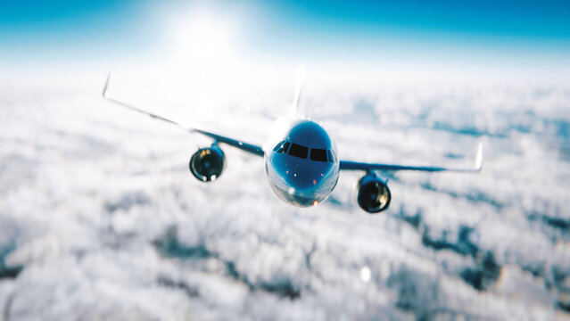 Commercial airplane is flying above clouds in a sunny sky