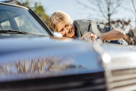 Woman cleaning her car