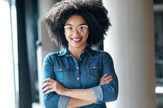 Young businesswoman with arms crossed smiling