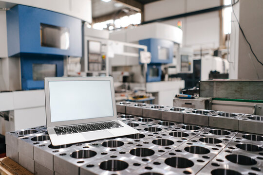 Laptop with blank screen in factory workshop