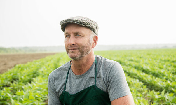 Portrait of farmer standing in front of a field