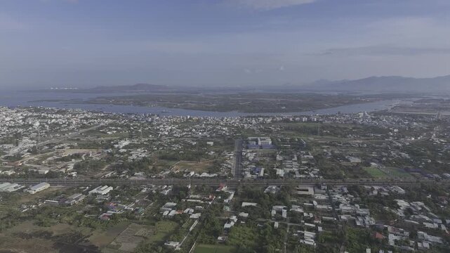Scenic coastal view of Vung Tau, Ho Chi Minh City, Vietnam, filmed from the sea toward Go Gang Island, revealing the city skyline, coastline and distant harbor facilities.
