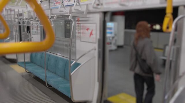 Young woman getting off a modern subway train
