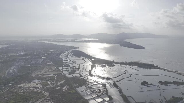 Aerial drone footage of Co May River estuary flowing into the sea in Ho Chi Minh City, Vietnam, featuring coastal wetlands, waterways, mangroves and scenic tropical shoreline.