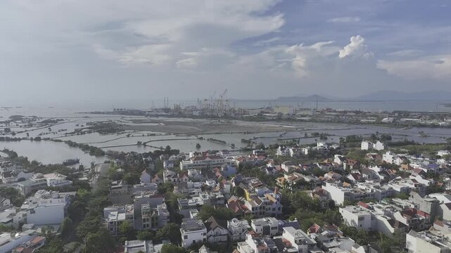 Scenic coastal view of Vung Tau, Ho Chi Minh City, Vietnam, filmed from the sea toward Go Gang Island, revealing the city skyline, coastline and distant harbor facilities.