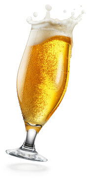 Tilting glass of cold beer with dynamic white foam splash (crown) isolated on a white background. Clipping Path.