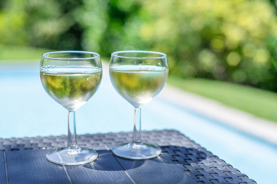 Two glasses of white wine on outdoor table