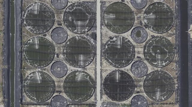 Aerial drone footage of sunrise over shrimp farms in Loc An, Ho Chi Minh City, Vietnam, featuring aquaculture ponds, golden reflections, coastal wetlands and sustainable seafood farming.