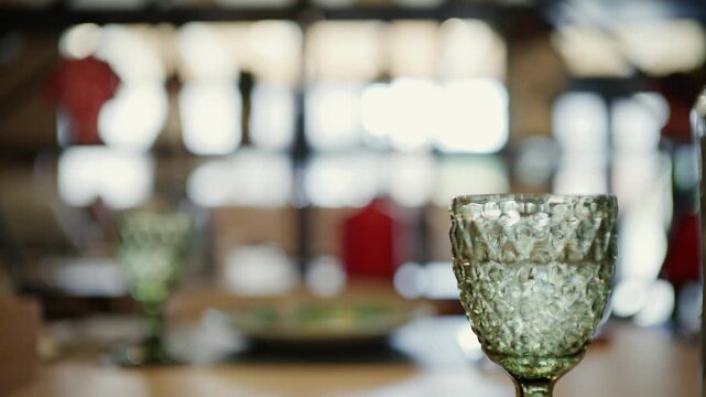 Elegant table setting with wine glasses and plate for celebratory dinner event.