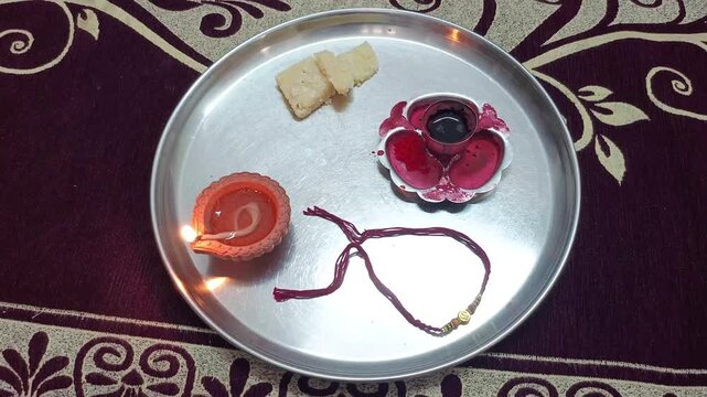 Traditional Raksha Bandhan Pooja Thali with Rakhi, Diya, Sweets, and Kumkum for Indian Festival Celebration