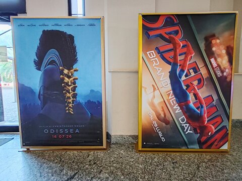 Ostia, Rome, Italy - July 22, 2026, advertising panels for the films Odyssey by director Christopher Nolan and Spider-Man: Brand New Day, directed by Destin Daniel Cretton, at the Cineland Multiplex.