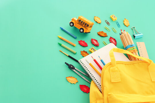 Back to school concept over pastel background. Top view