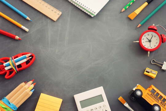 Back to school concept over classroom blackboard. Top view