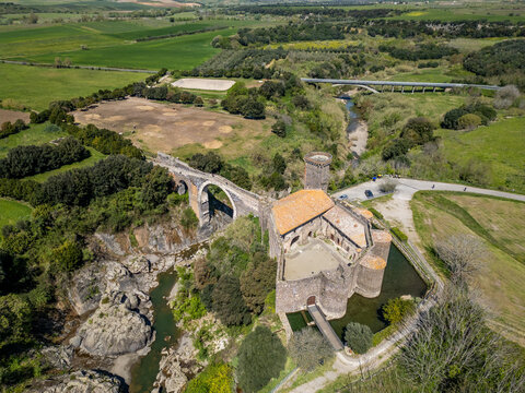 Aerial view of the Badia castle and Devil's bridge over the Fiora river gorge at Vulci, Lazio, Italy