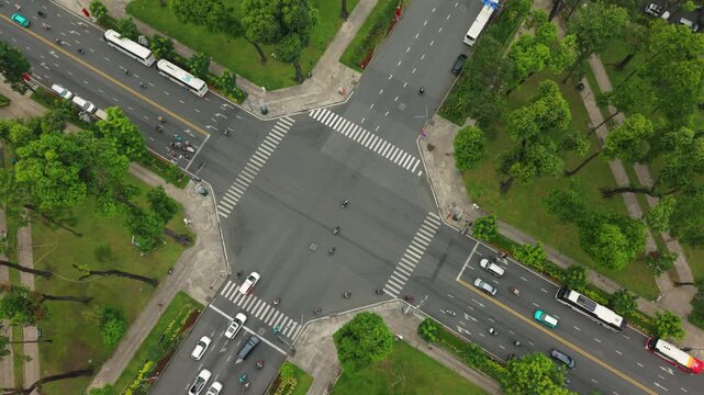 Vietnam, Ho Chi Minh Aerial Intersection Ho Chi Minh Morning Showing Sparse Vehicles Crossing Octagonal Junction Bordered By Green Park And Walking Paths, Drone Perspective Captures