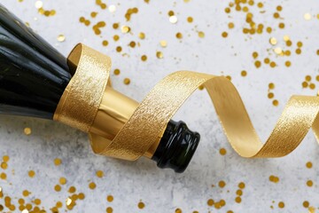 Fototapeta premium The Champagne Bottle Wrapped in Golden Ribbon for Festive Celebration