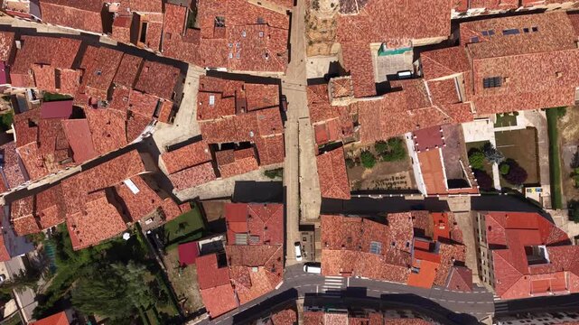 Top-down view of La Iglesuela del Cid village in Maestrazgo, Teruel, Spain, revealing terracotta rooftops, medieval street layout and a historic church tower