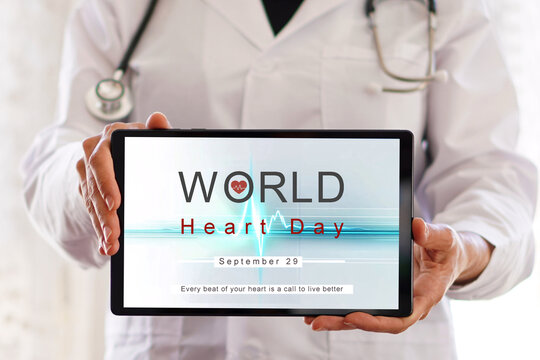 September 29. World Heart Day. Female doctor showing the message on a digital tablet.