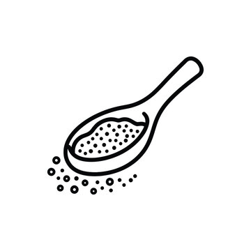 Black and white slotted spoon with scattered food particles