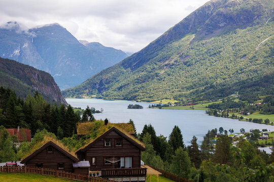 Traditional wooden house with grass roof overlooking a Norwegian fjord