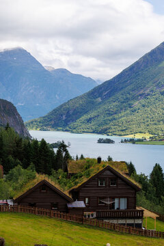 Traditional wooden house with grass roof overlooking a Norwegian fjord