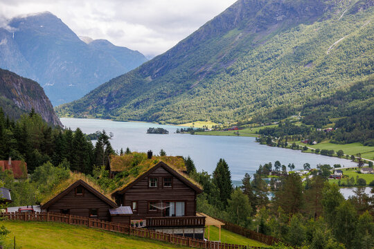 Traditional wooden house with grass roof overlooking a Norwegian fjord