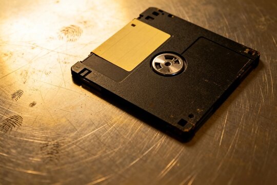 Vintage floppy disk on scratched metal surface