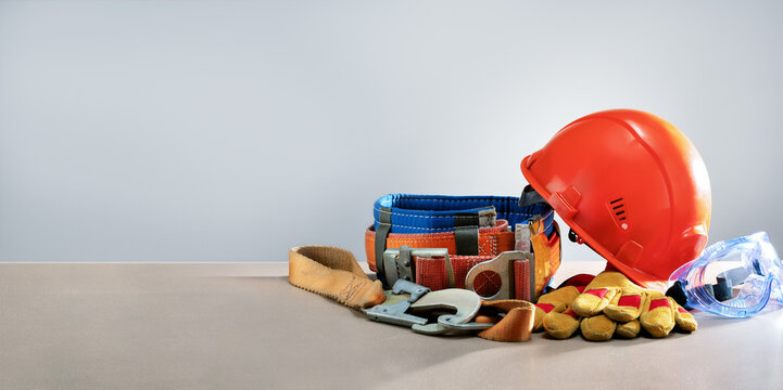 Personal protective equipment on light grey background with copy space. Safety work concept.
