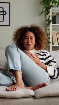 Emotional woman watching movie eating popcorn