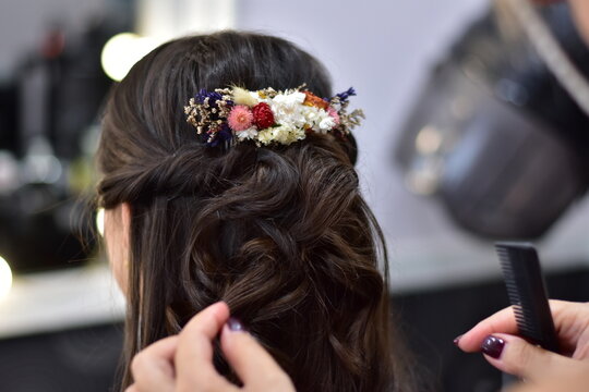 Bridal half updo with flowers hairstyle at the salon