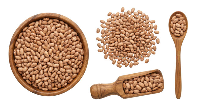 Pinto beans in wooden bowl on white background with scattered beans spoon and scoop full of pinto beans.