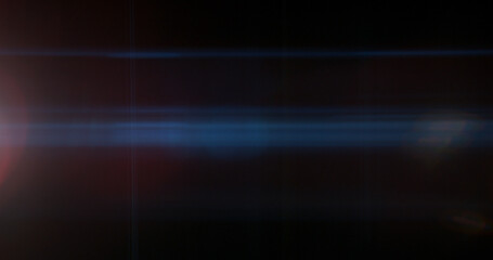 Obraz na płótnie Canvas Abstract cinematic anamorphic lens flare overlay with blue horizontal light streaks and warm orange glow on a black background. Ideal VFX element for compositing, titles and film editing.