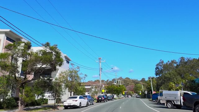 Vehicle Driving Through Suburban Gold Coast Intersection on Sunny Day